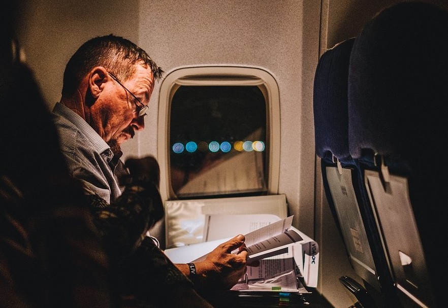 man reading in a plane