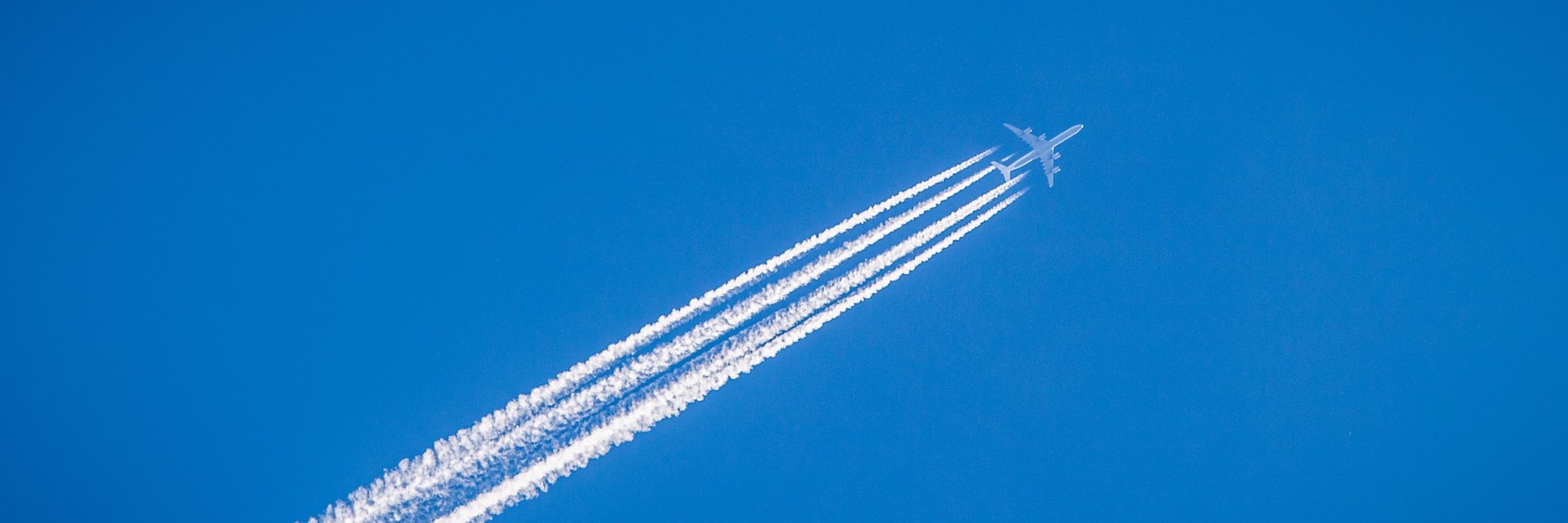 plane flyign towards dark clouds