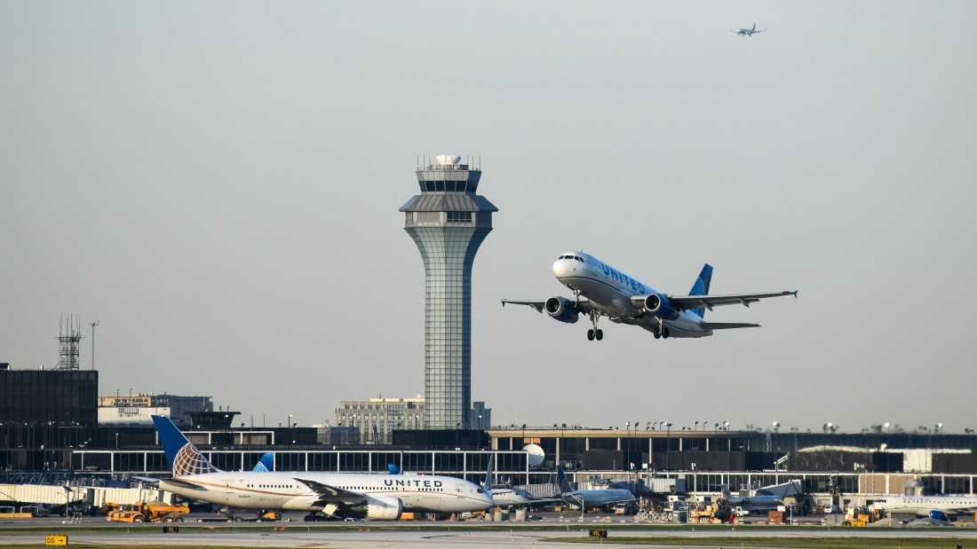 plane taking off from airport with control tower